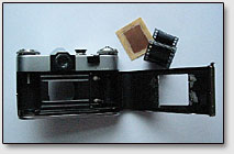 Фото. 3. Полуразобранный фотоаппарат "Зенит", текстолитовая плата и кусочек фотоплёнки.